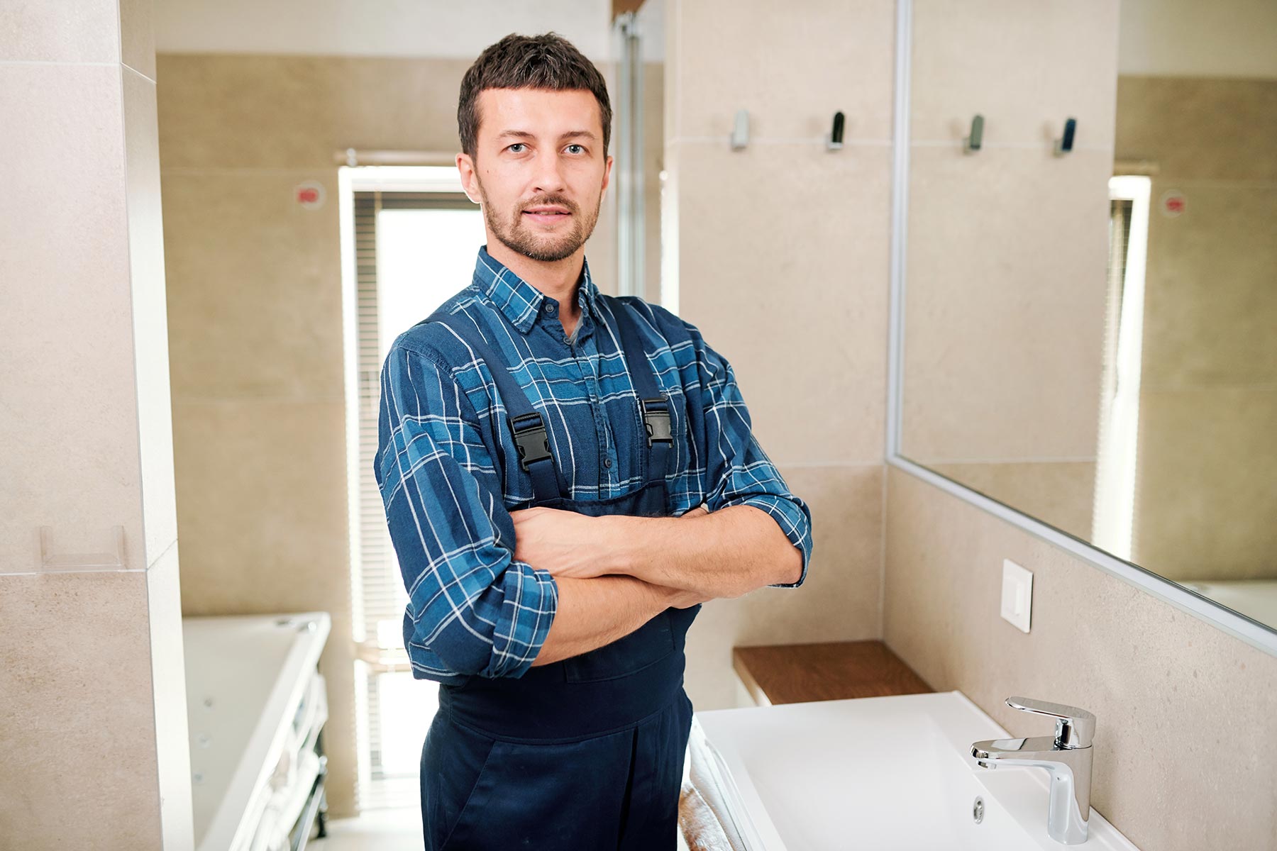 young-successful-plumber-in-workwear-standing-in-b-3P7U6YB-3.jpg